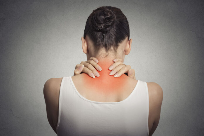 Back spine disease. Closeup view tired female massaging her neck